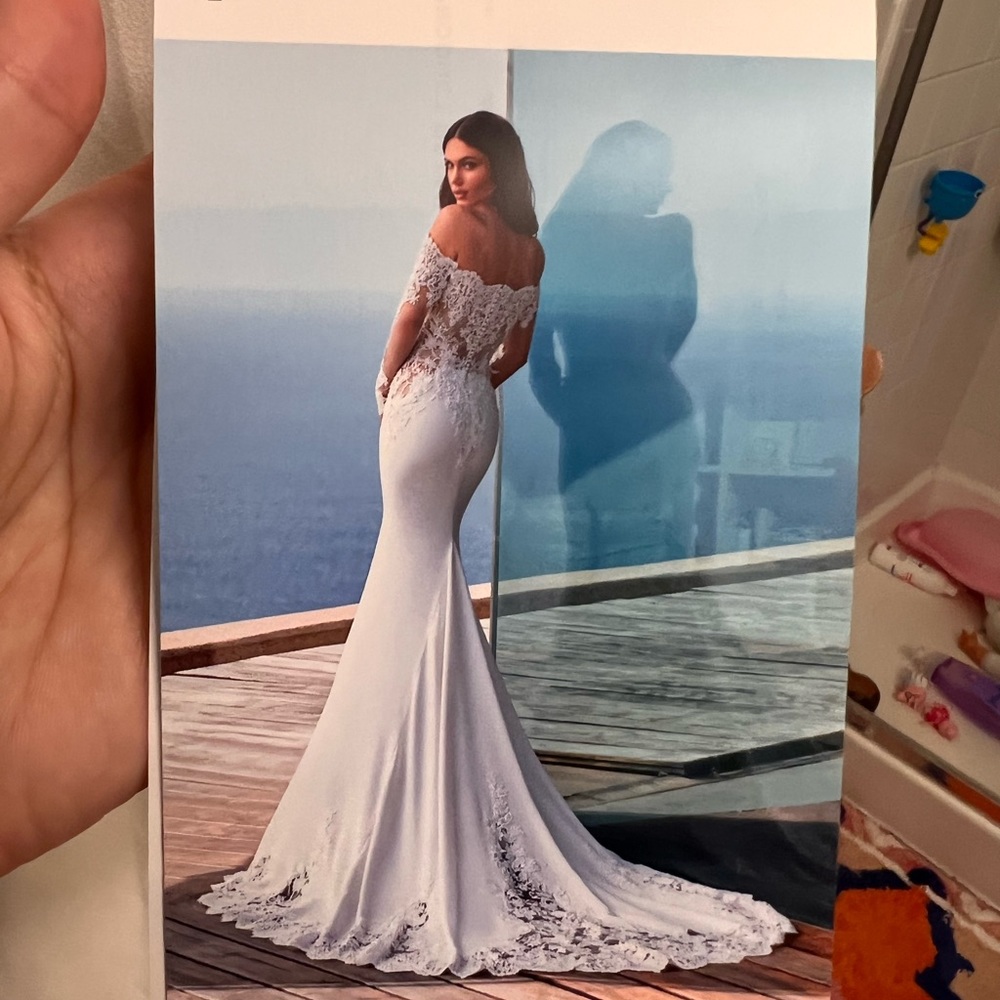 Size 10 off shoulder Pronovias wedding gown in off white.